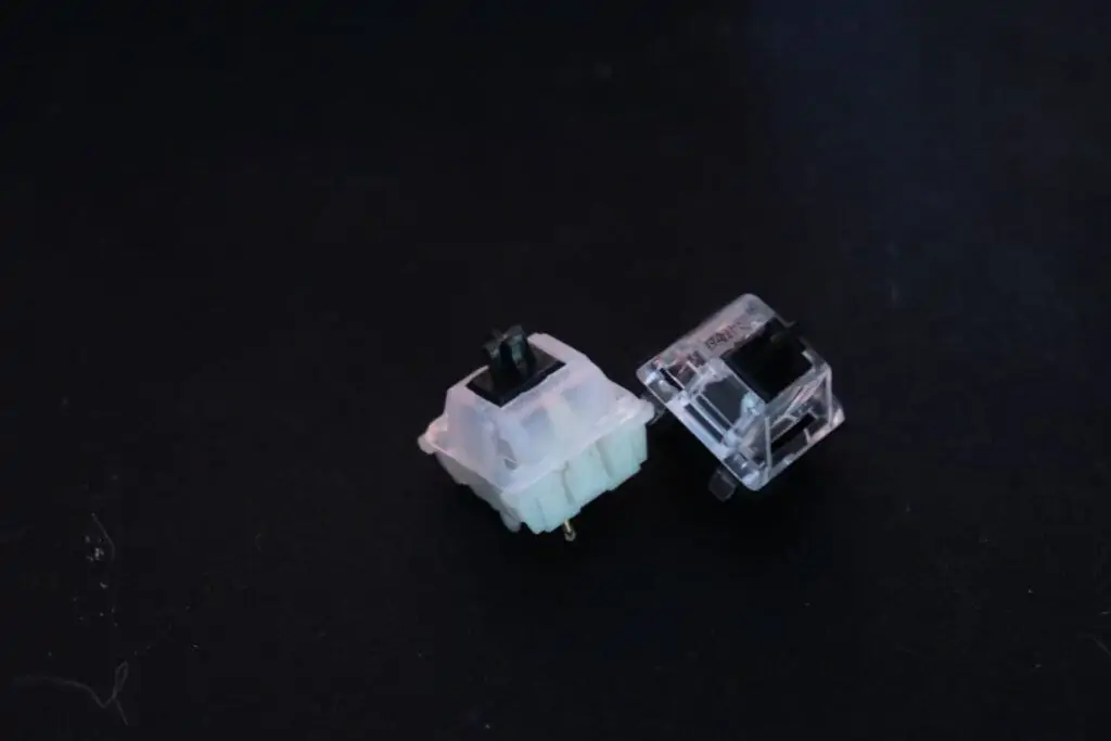 Regular Gateron switch next to milky Gateron switch.