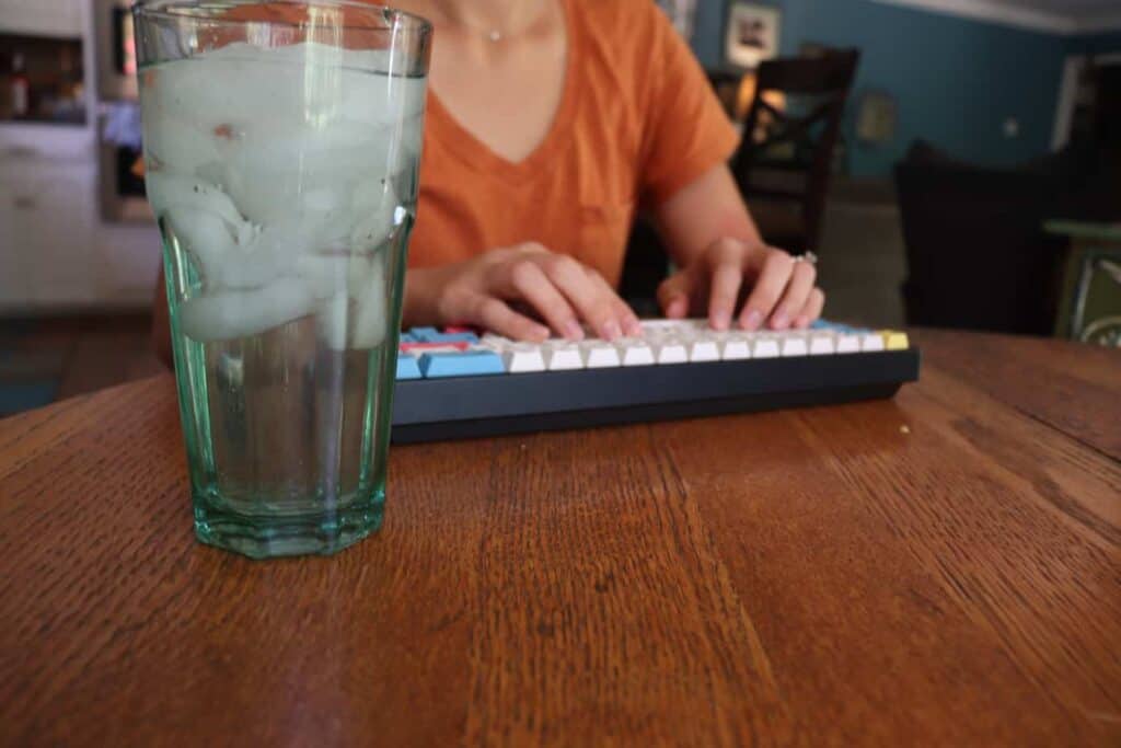 Glass of water by mechanical keyboard