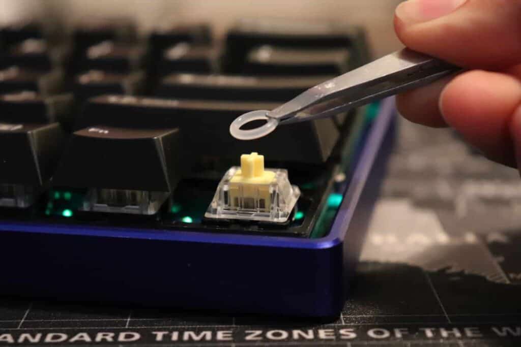 an o-ring being put on a mechanical keyboard switch