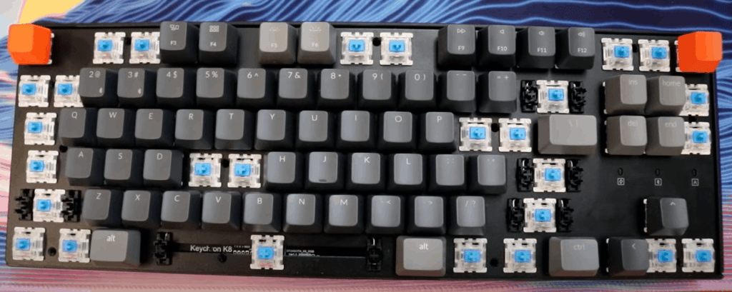 Mechanical keyboard with top plate that has been unscrewed