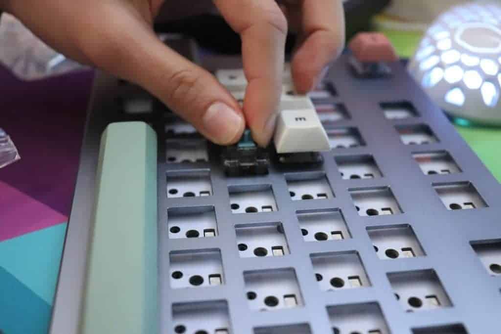 switches being inserted into mechanical keyboard 