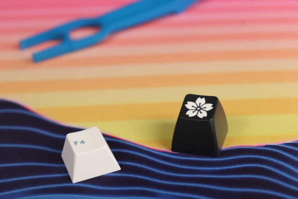 Different kinds of double-shot keycaps next to each other on a deskmat.