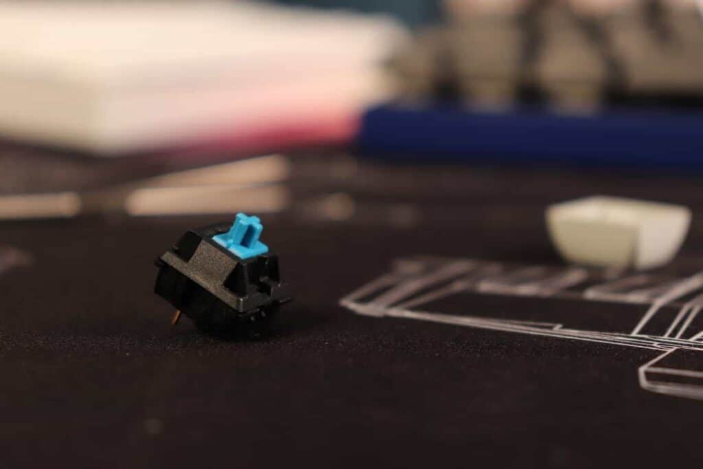 Cherry MX Blue mechanical keyboard switch on a deskmat