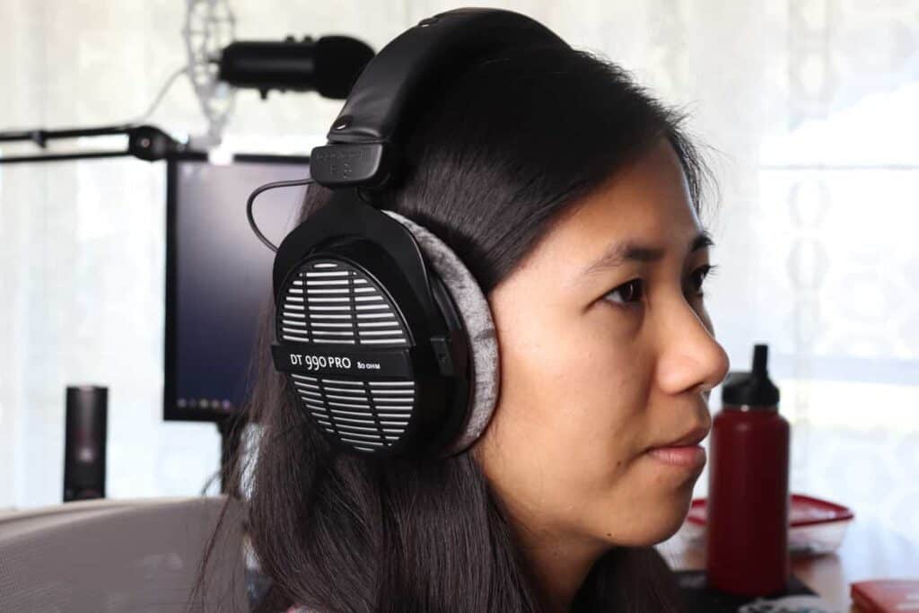 Someone wearing open-back headphones in office