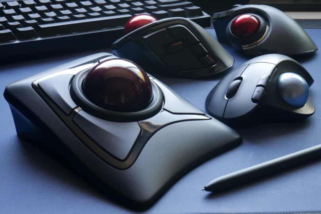 A variety of trackball mice on a desk