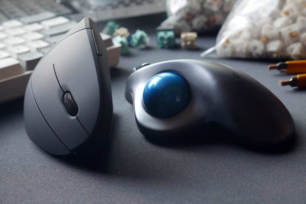 Anker Vertical Mouse next to Logitech M570 Trackball mouse